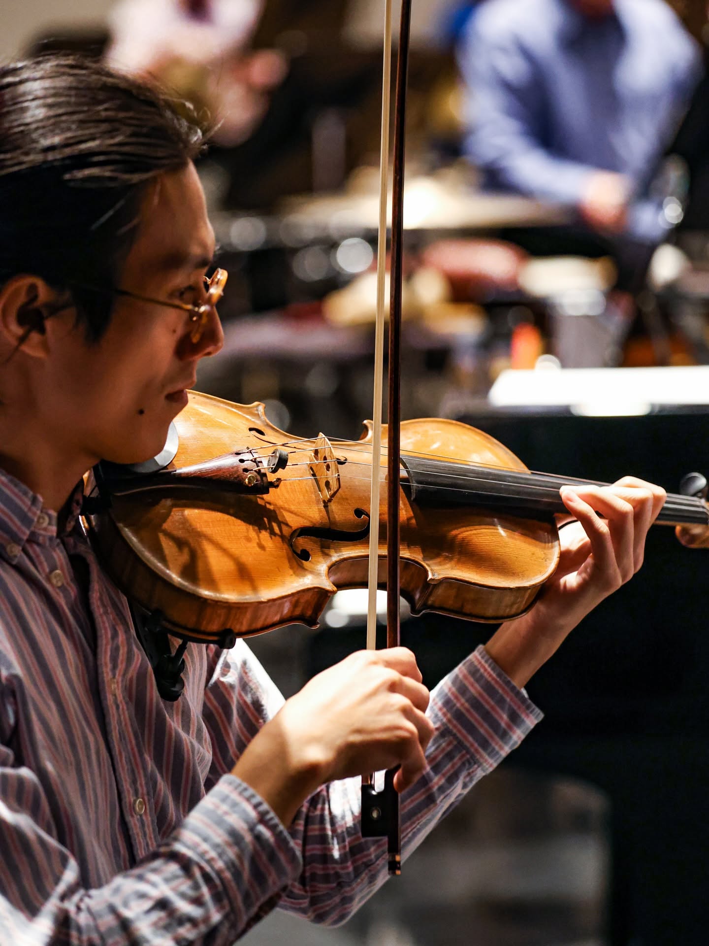 Kai playing violin on stage